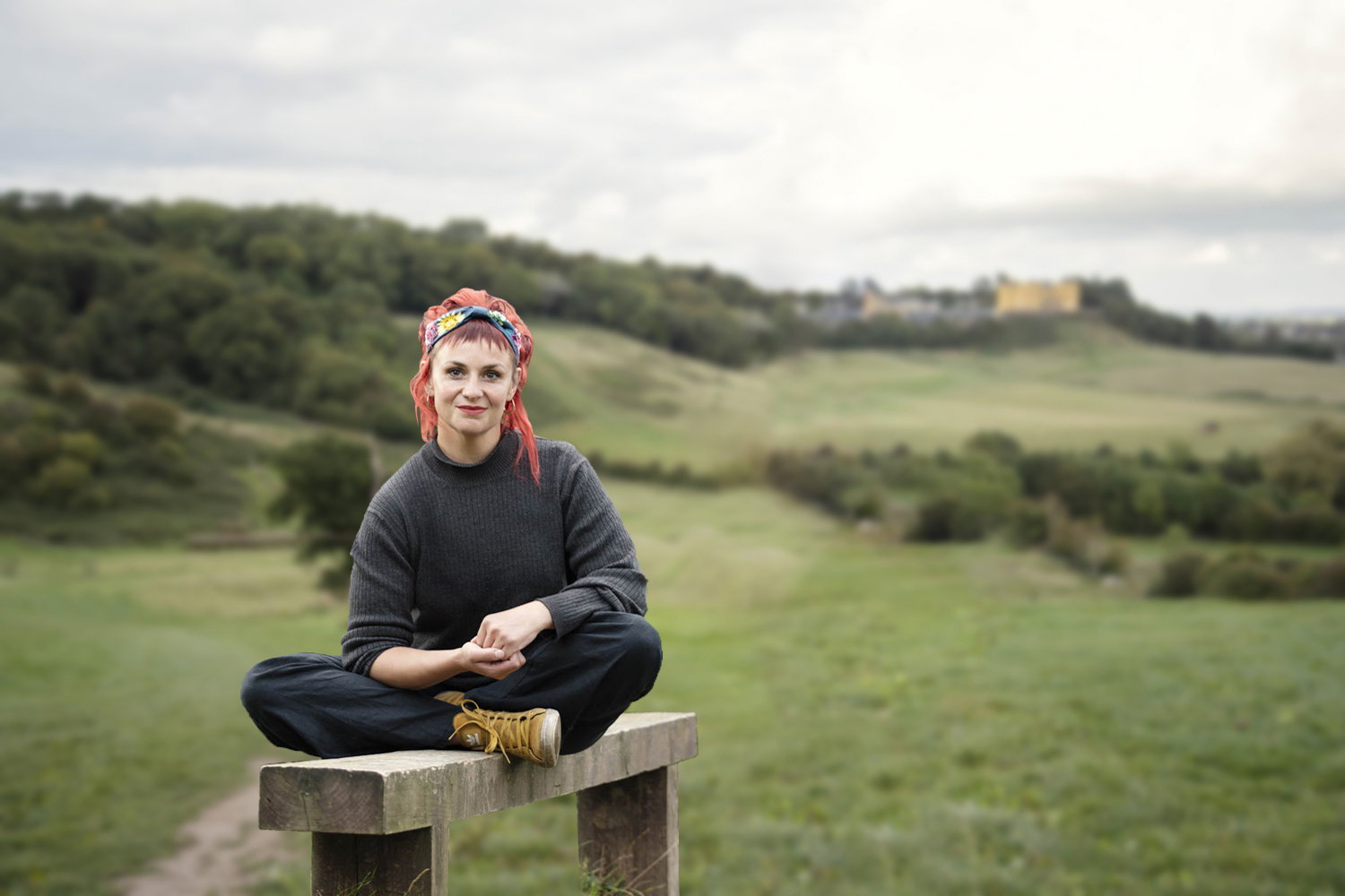 Clare sat on wooden bench from I Do Declare, a Celebrant from Bristol
